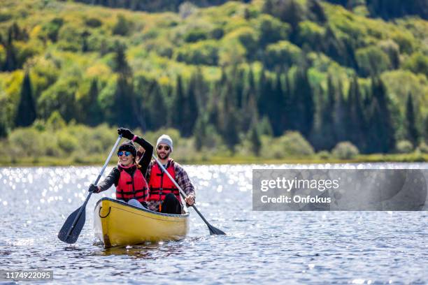 couple canoeing at parc national du mont-tremblant, quebec, canada - quebec landscape stock pictures, royalty-free photos & images