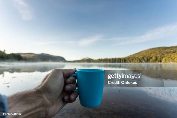 man drinking coffee by the lake in camping in autumn - fog camper stock pictures, royalty-free photos & images