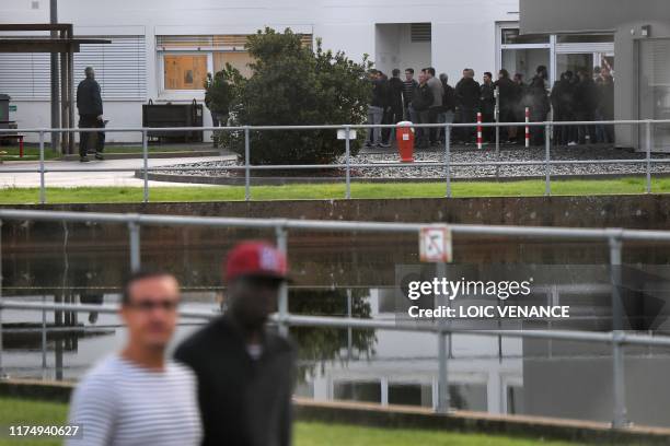Employees wait to take part in an information meeting focused on the site future, on October 10, 2019 at the Michelin factory in La Roche sur Yon.