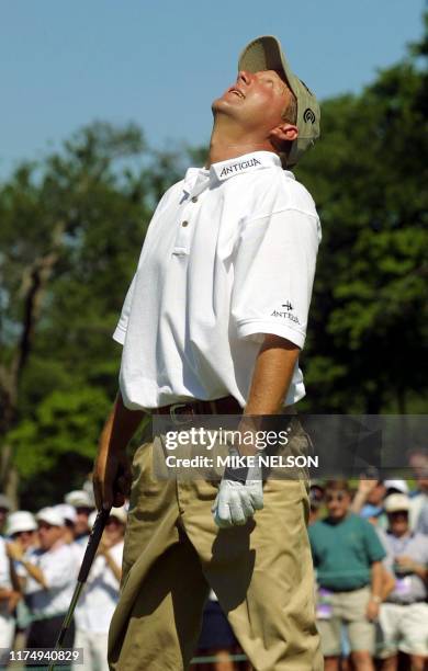 Former PGA Champion Mark Brooks of the US looks to the sky after sinking a putt to save par on the 18th hole during the second round of the 2001 US...