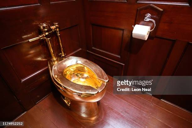 America", a fully-working solid gold toilet, created by Maurizio Cattelan, is seen at Benheim Palace on September 12, 2019 in Woodstock, England. The...