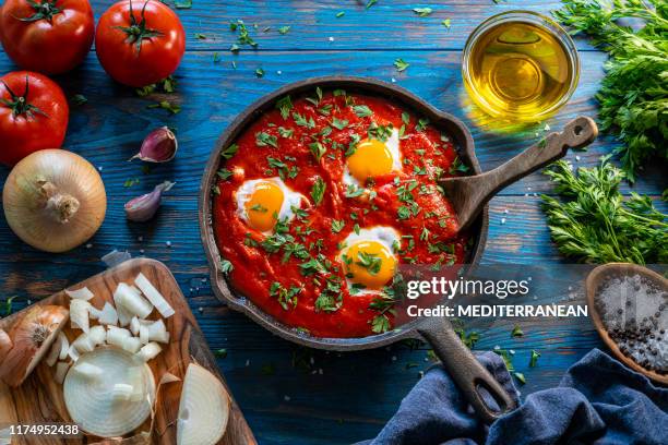 shakshouka poached eggs on tomato sauce - oregano stock pictures, royalty-free photos & images