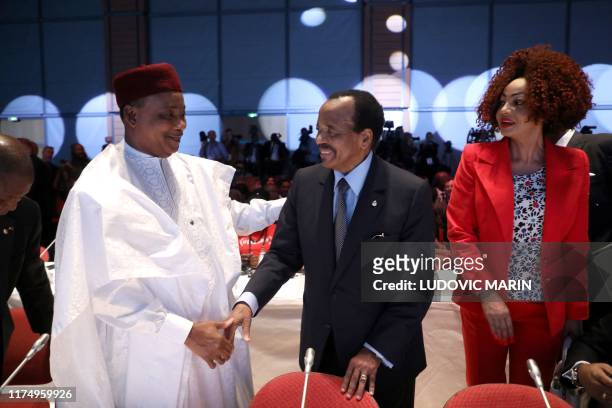 Niger president Mahamadou Issoufou, Cameroon president Paul Biya and his wife Chantal arrive on the second day of the conference of Global Fund to...