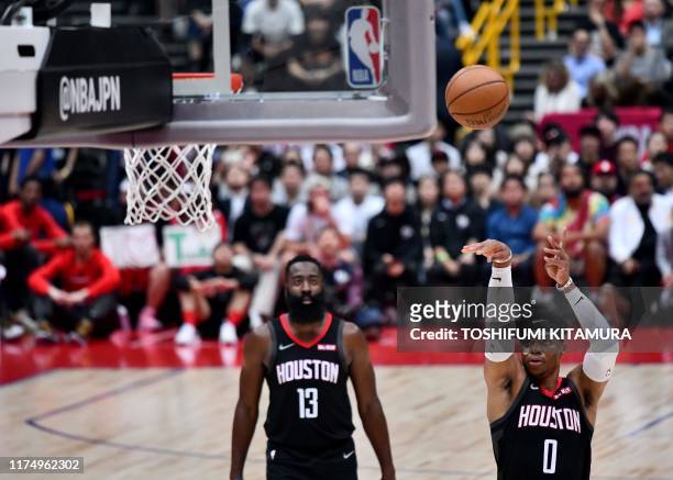 Houston Rockets guard Russell Westbrook shoots a free throw as teammate James Harden looks on during the National Basketball Association Japan Games...