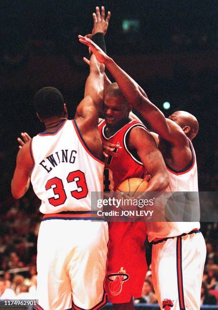 Miami Heat plyer Jamal Mashburn is sandwiched between New York Knicks Patrick Ewing and Larry Johnson during their NBA Eastern Conference semi-final...