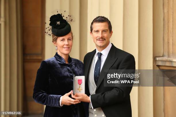 Bear Grylls poses with his wife Shara as he holds his OBE following an investiture ceremony at Buckingham Palace, on October 10, 2019 in London,...