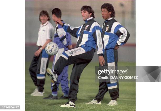 Uruguayan captain Enzo Francescoli dribbles the ball in front of teammate Robert Siboldi during a practice session 29 April in Asuncion. The team is...