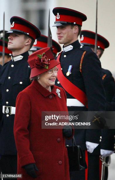 Britain's Prince William breaks into a smile as he is inspected by his grandmother Queen Elizabeth II, during the Sovereign's Parade at The Royal...