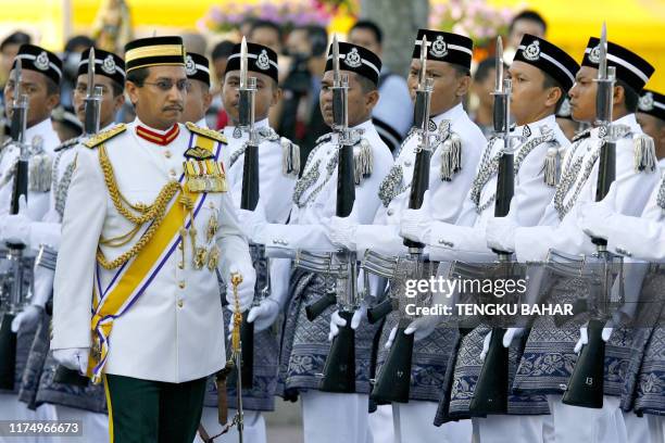 Malaysian King Tuanku Mizan Zainal Abidin inspects a police honour guard during a parade celebrating the Royal Malaysian Police's 200th anniversary...