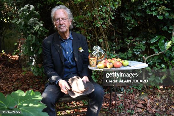 Austrian writer Peter Handke poses in his garden in Chaville, in the Paris surburbs, on October 10, 2019 after he was awarded with the 2019 Nobel...