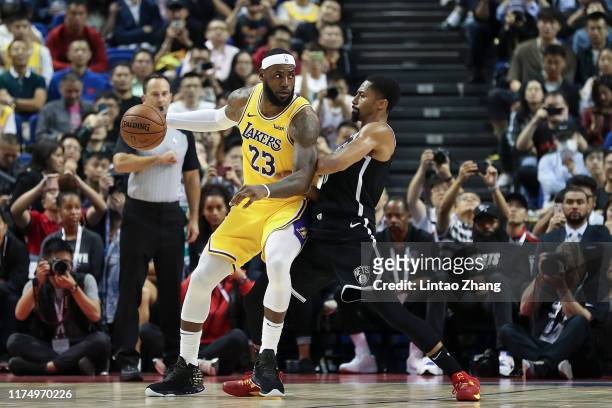 LeBron James of the Los Angeles Lakers in action against Spencer Dinwiddie of the Brooklyn Nets during a preseason game as part of 2019 NBA Global...