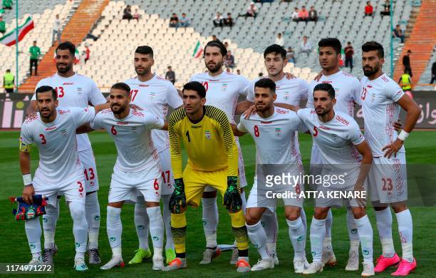 Iran's players pose for a group picture ahead of the World Cup Qatar 2022 Group C qualification football match between Iran and Cambodia at the Azadi...