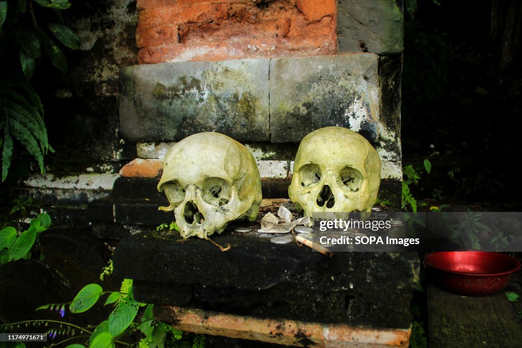 Two skulls greet visitors at the Trunyan Village Cemetery,...