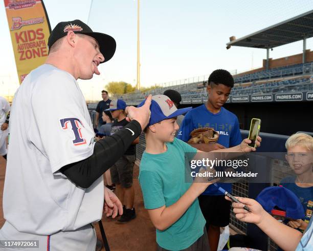 Jax Biggers of the Surprise Saguaros poses for a photo with fans before the game against the Peoria Javelinas at Peoria Stadium on Sunday, September...