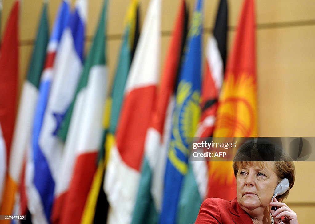 German Chancellor Angela Merkel looks on