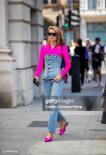 Jessica Minkoff is seen wearing denim corset and jeans, pink top, bag, heels outside Victoria Beckham during London Fashion Week September 2019 on...