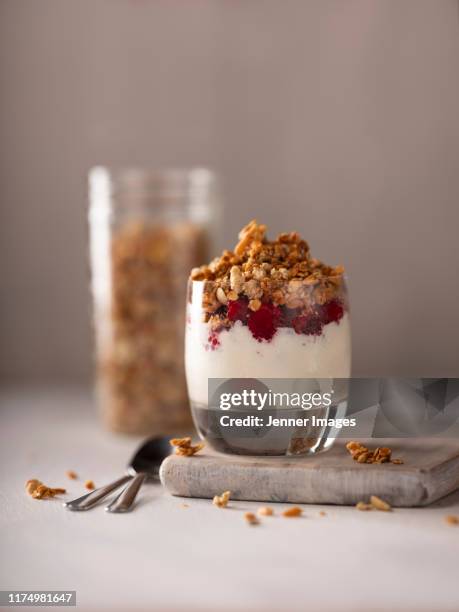 layered yoghurt and granola pot with fresh raspberry. - parfait stock pictures, royalty-free photos & images