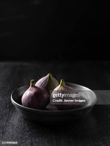 three fresh figs in a bowl. - fig stock pictures, royalty-free photos & images