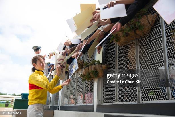Jockey Nanako Fujita gives her autograph to Japanese racing fans after Kimon Boy winning the Race 4 at Sapporo Racecourse on August 25, 2019 in...