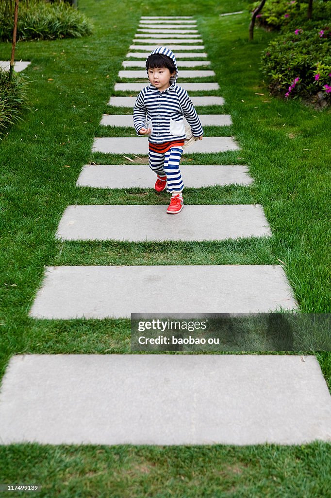 Boy walking in garden