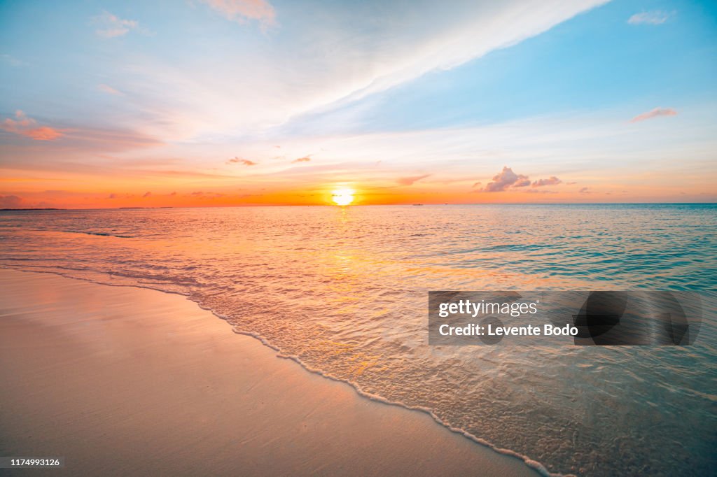 Sunset sea landscape. Colorful ocean beach sunrise. Beautiful beach scenery with calm waves and soft sandy beach. Empty tropical landscape, horizon with scenic coast view. Colorful nature sea sky