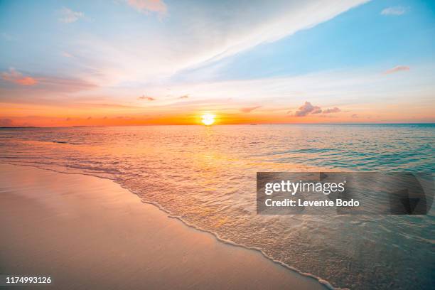 sunset sea landscape. colorful ocean beach sunrise. beautiful beach scenery with calm waves and soft sandy beach. empty tropical landscape, horizon with scenic coast view. colorful nature sea sky - beach waves fotografías e imágenes de stock