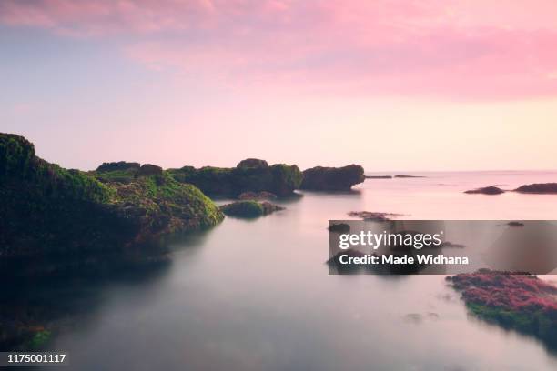 long exposure beach rocks at sunset - made widhana stock pictures, royalty-free photos & images