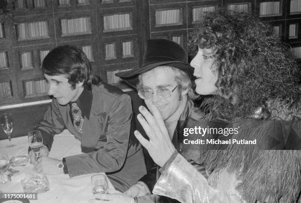English singer and guitarist Marc Bolan on right with singer and pianist Elton John and his manager John Reid at the UK premiere of the T Rex concert...
