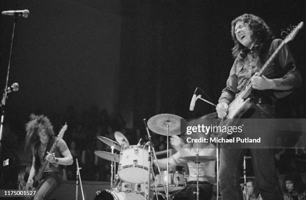 Irish singer and guitarist Rory Gallagher performs live on stage with bassist Gerry McAvoy and drummer Wilgar Campbell at Leeds City Hall in Leeds,...
