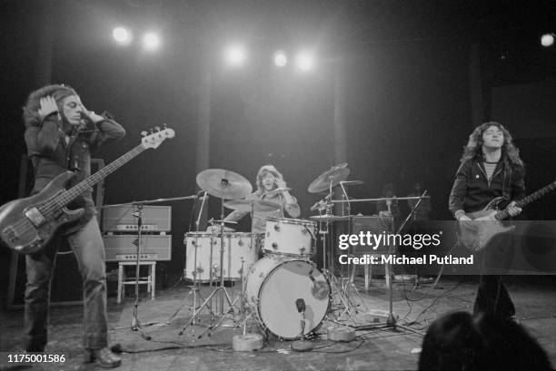 Irish singer and guitarist Rory Gallagher performs live on stage with bassist Gerry McAvoy and drummer Wilgar Campbell at the Roundhouse in Chalk...