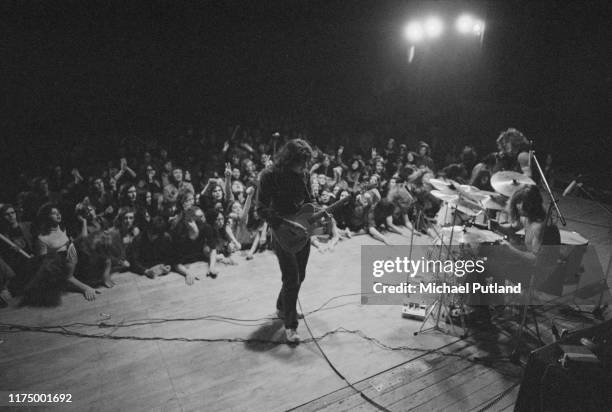 Irish singer and guitarist Rory Gallagher performs live on stage with bassist Gerry McAvoy and drummer Wilgar Campbell at Leeds City Hall in Leeds,...
