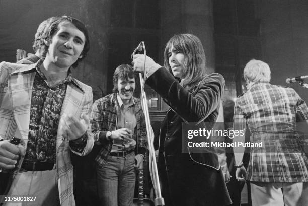 From left, Elton John's manager John Reid, Muff Winwood, drummer Nigel Olsson and Elton John together on stage at the Rocket Records launch party at...