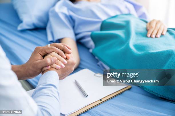 close-up hands of expert doctors takes care patients - visiting patient in hospital stock pictures, royalty-free photos & images