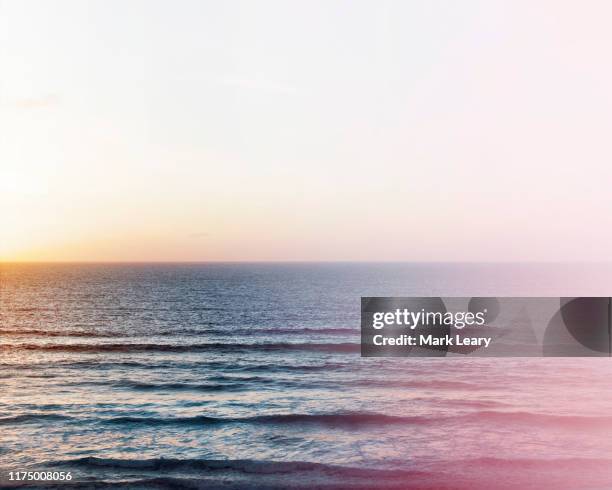 storm affected sea as wind blow the waves and the sun sets - watergate stock pictures, royalty-free photos & images