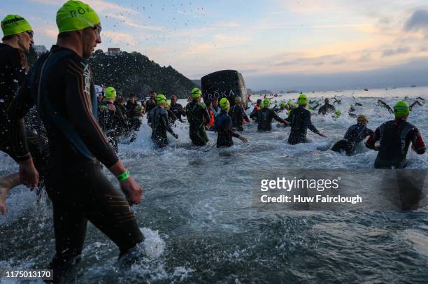 Athletes enter the water to start the swim section of the race in IRONMAN Wales on on September 15, 2019 in Tenby, Wales.