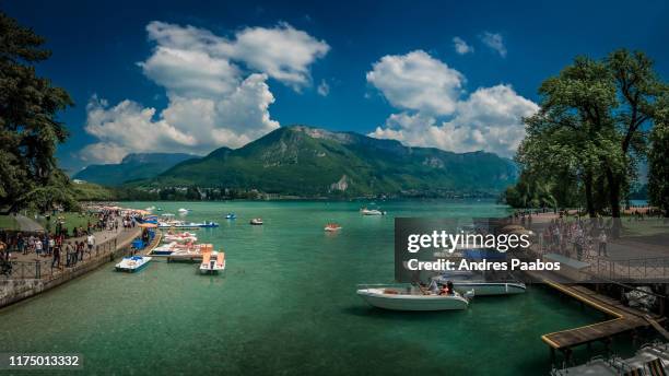 boats anchored in an alpine lake with crystal clear water - annecy stock pictures, royalty-free photos & images