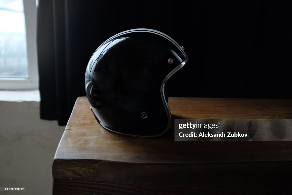 Overhead view of biker accessories placed on rustic wooden table. Items included motorcycle helmet, gloves, keys,. Motorcycle travel dream concept.