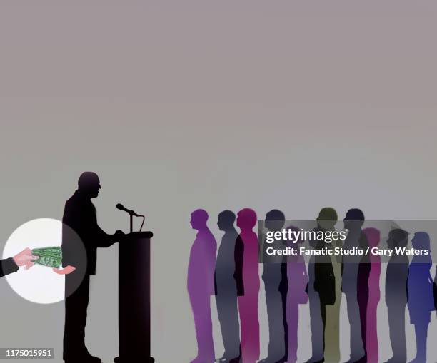 concept image of a speaker secretly accepting money in front of a large group of people depicting corruption. - corrupt politician stock illustrations