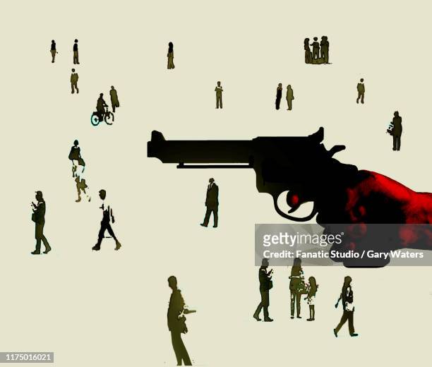 concept image of a hand holding a gun against a background of people depicting gun crime in society - murderer stock-grafiken, -clipart, -cartoons und -symbole