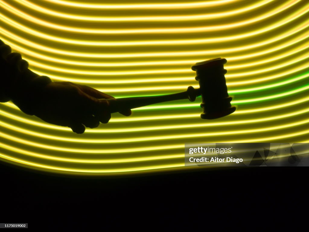 Judge's hammer in a futuristic yellow environment
