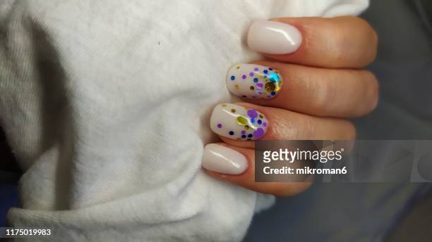 close-up of woman fingers with nail art manicure with white colour - ombre stock-fotos und bilder