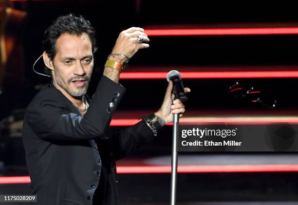 Singer Marc Anthony tosses his sunglasses into the crowd as he performs during the kickoff of his Opus tour at The Zappos Theater at Planet Hollywood...