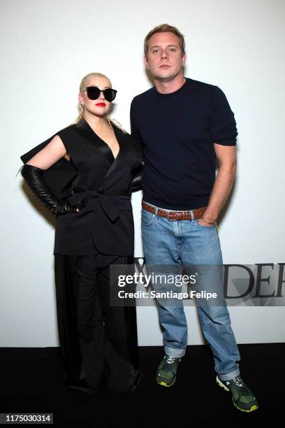 Christina Aguilera and designer Jonathan Anderson pose for photos backstage after 'JW Anderson S/S 2020' fashion show during London Fashion Week...