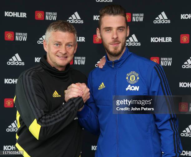 David de Gea of Manchester United poses with Manager Ole Gunnar Solskjaer after signing a new contract with the club at Aon Training Complex on...
