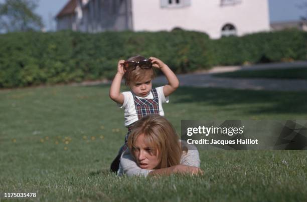 Nathalie Delon and her son Anthony Delon playing in the garden at Tancrou, France, 4th May 1966