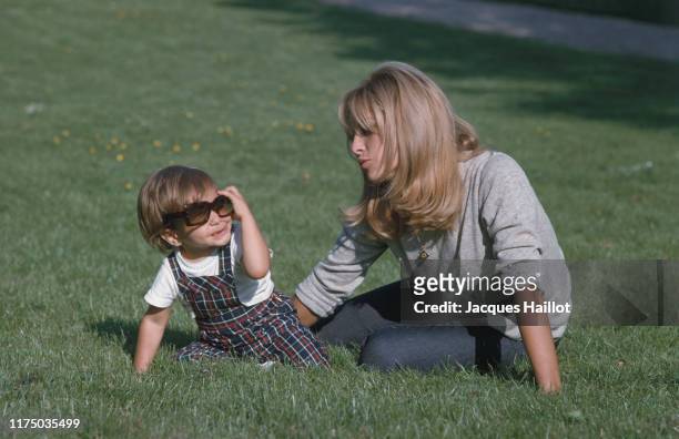 Nathalie Delon and her son Anthony Delon playing in the garden at Tancrou, France, 4th May 1966