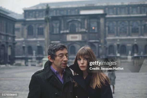 French singer and songwriter Serge Gainsbourg and his partner British singer and actress Jane Birkin in the courtyard of the French National College...