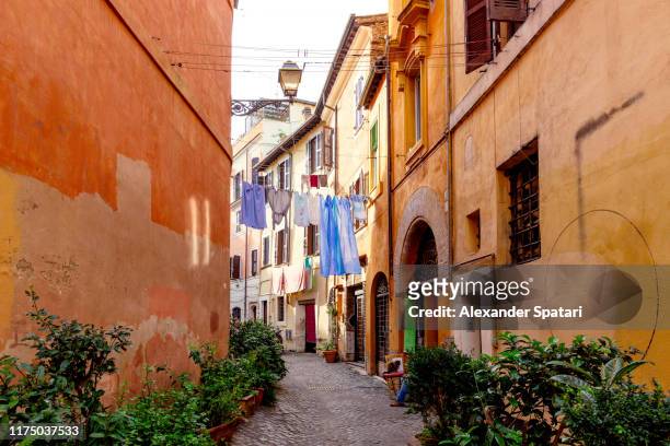 beautiful cobbled street in rome, italy - trastevere stock-fotos und bilder
