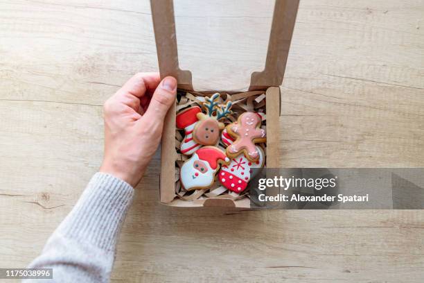 opening christmas present with christmas cookies, personal perspective view - christmas treat stock pictures, royalty-free photos & images