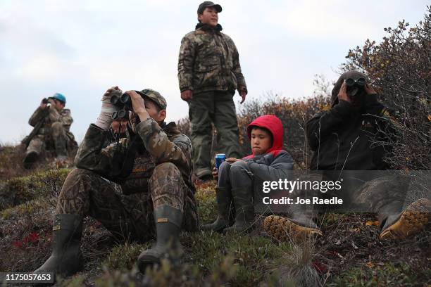 Tommy Swan , Tommy Swan Jr. And Clinton Swan keep an eye on moose that they can see but are too far away to shoot as they hunt along the Wulik river...